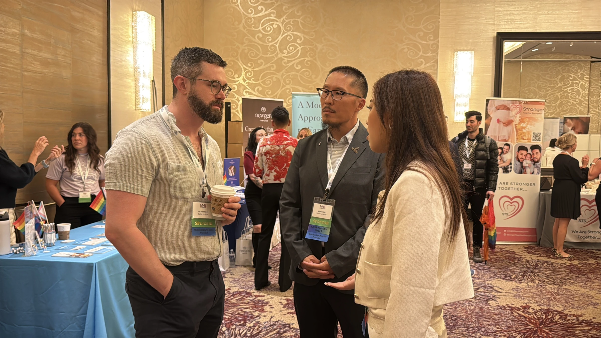 Yunda Surrogacy team in conversation in the expo hall · MHB New York 2026